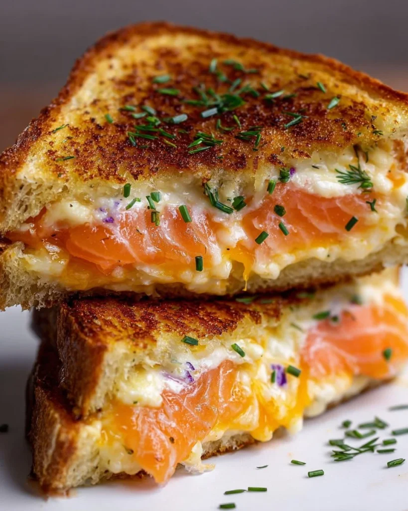Smoked salmon grilled cheese sandwich with melted cheese and herbs