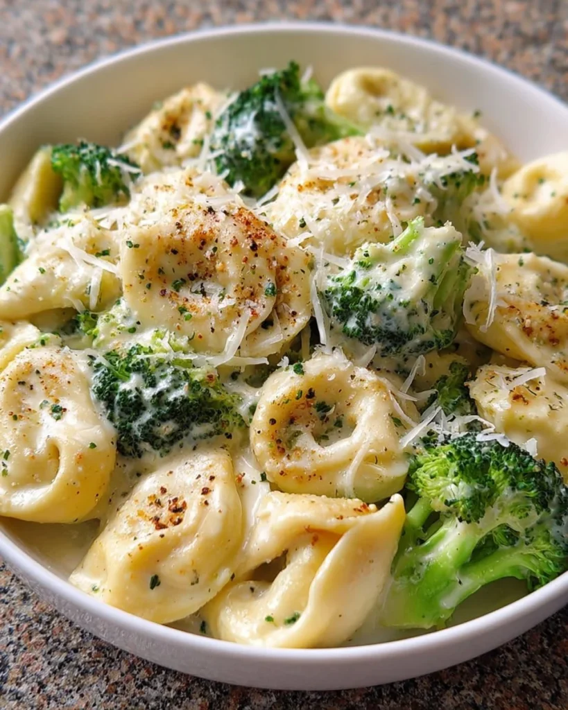 Plate of creamy Alfredo Tortellini garnished with parsley