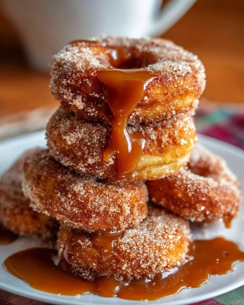 Freshly baked Caramel Apple Cider Donuts topped with caramel drizzle