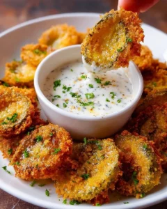 Crispy fried banana peppers with ranch dip on a serving plate