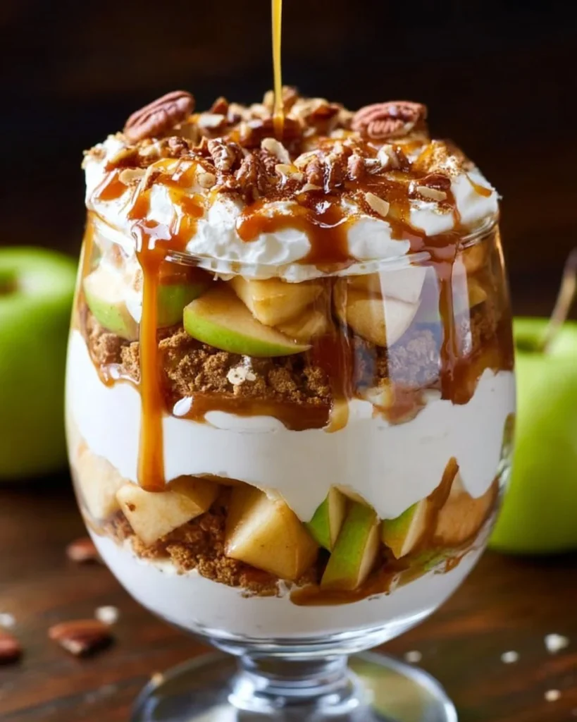Delicious caramel apple trifle with layers of apples, cream, and caramel sauce.