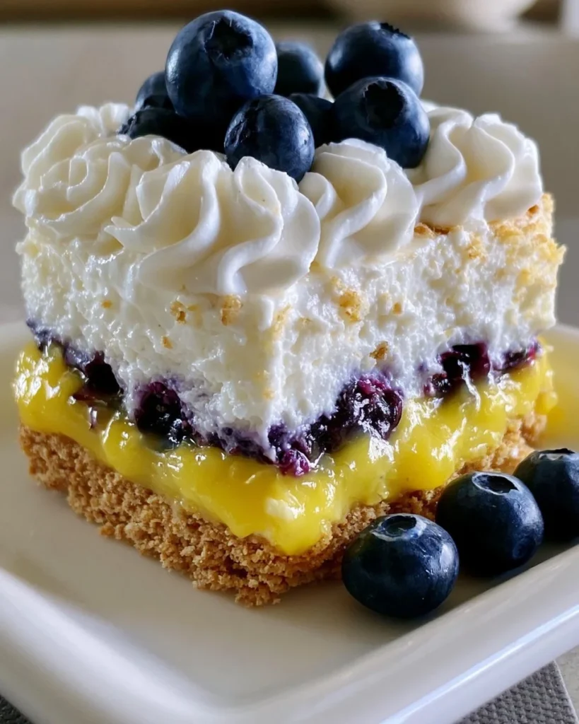 Layered lemon blueberry cake with fresh blueberries and zesty lemon icing