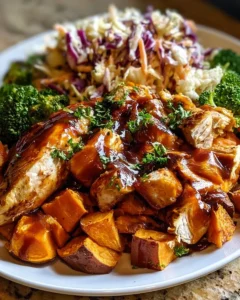 Delicious BBQ chicken served over roasted sweet potatoes in a vibrant bowl