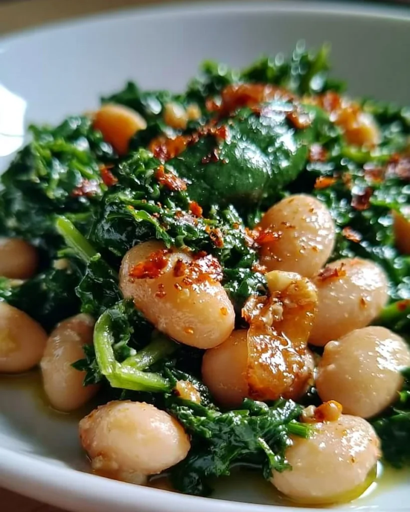 A delicious dish of spinach and white beans garnished with herbs.